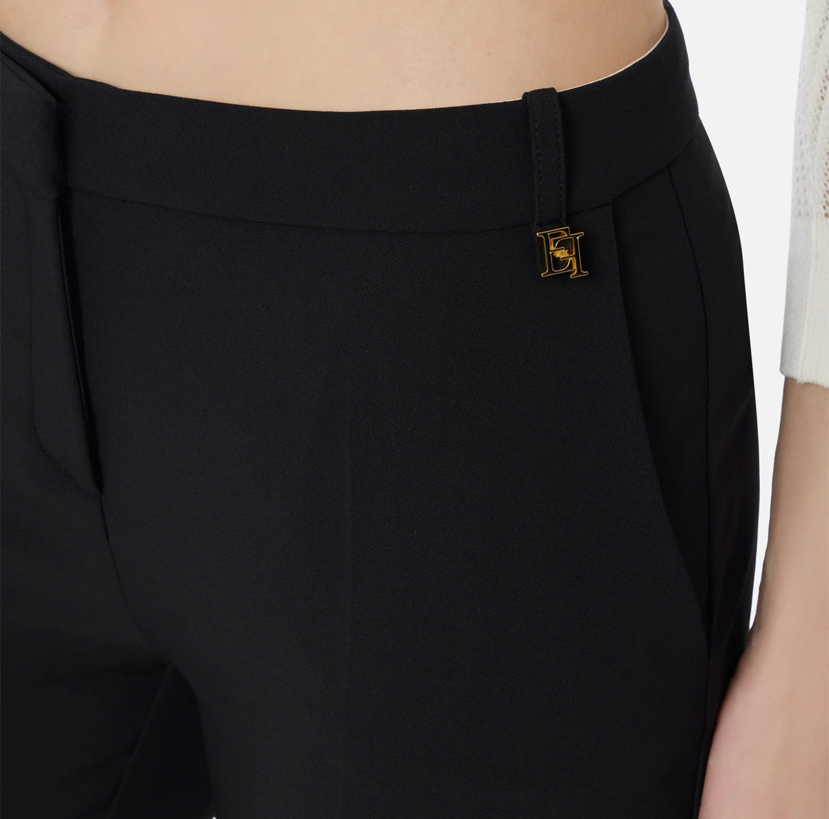 Trousers in lightweight crêpe fabric with logo charm