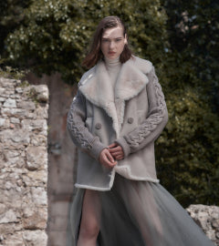 Shearling coat with knitted sleeve