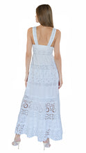 Temptation Positano Long maxi dress with crochet lace trim, a scallop plunge v-neckline with a smocked empire waist and pom pom trim in white